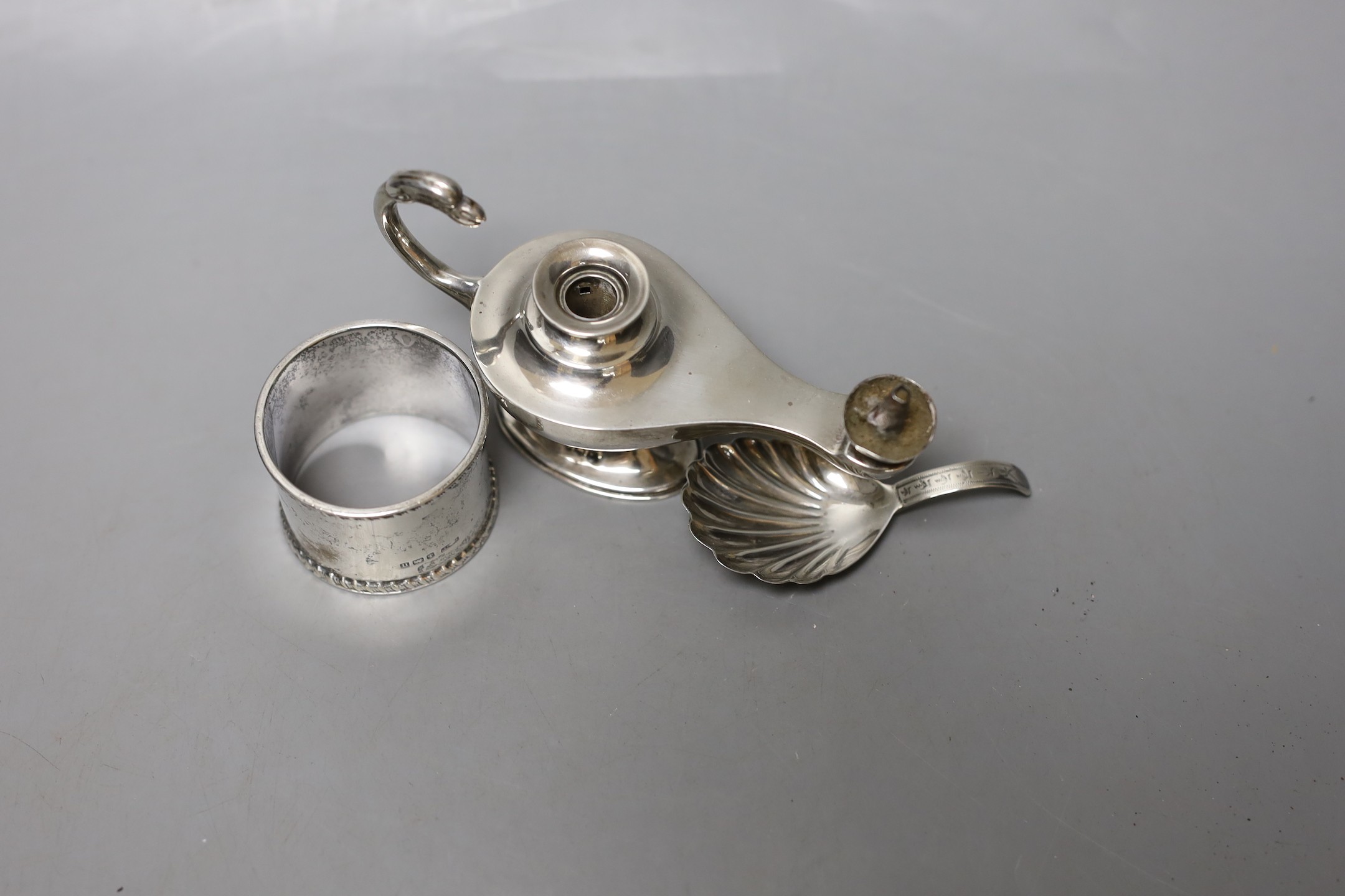 A George V silver 'Aladdin's Lamp' lighter (lacking cover), length 12cm, a silver napkin ring and a William IV silver caddy spoon, William Bateman, London, 1835.